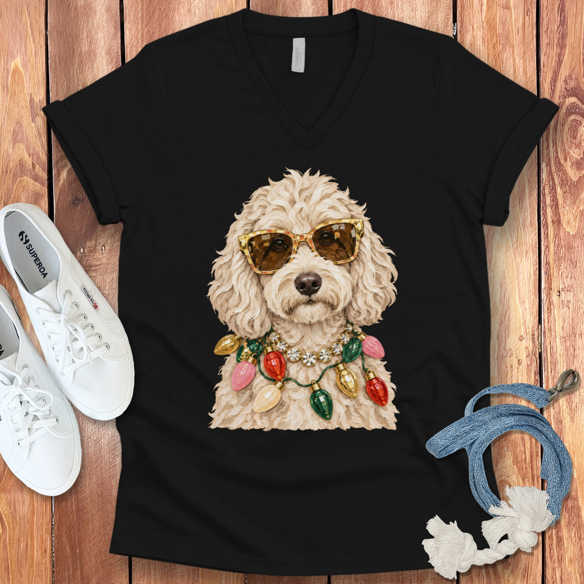 Black t-shirt featuring a poodle wearing sunglasses and a string of colorful Christmas lights.