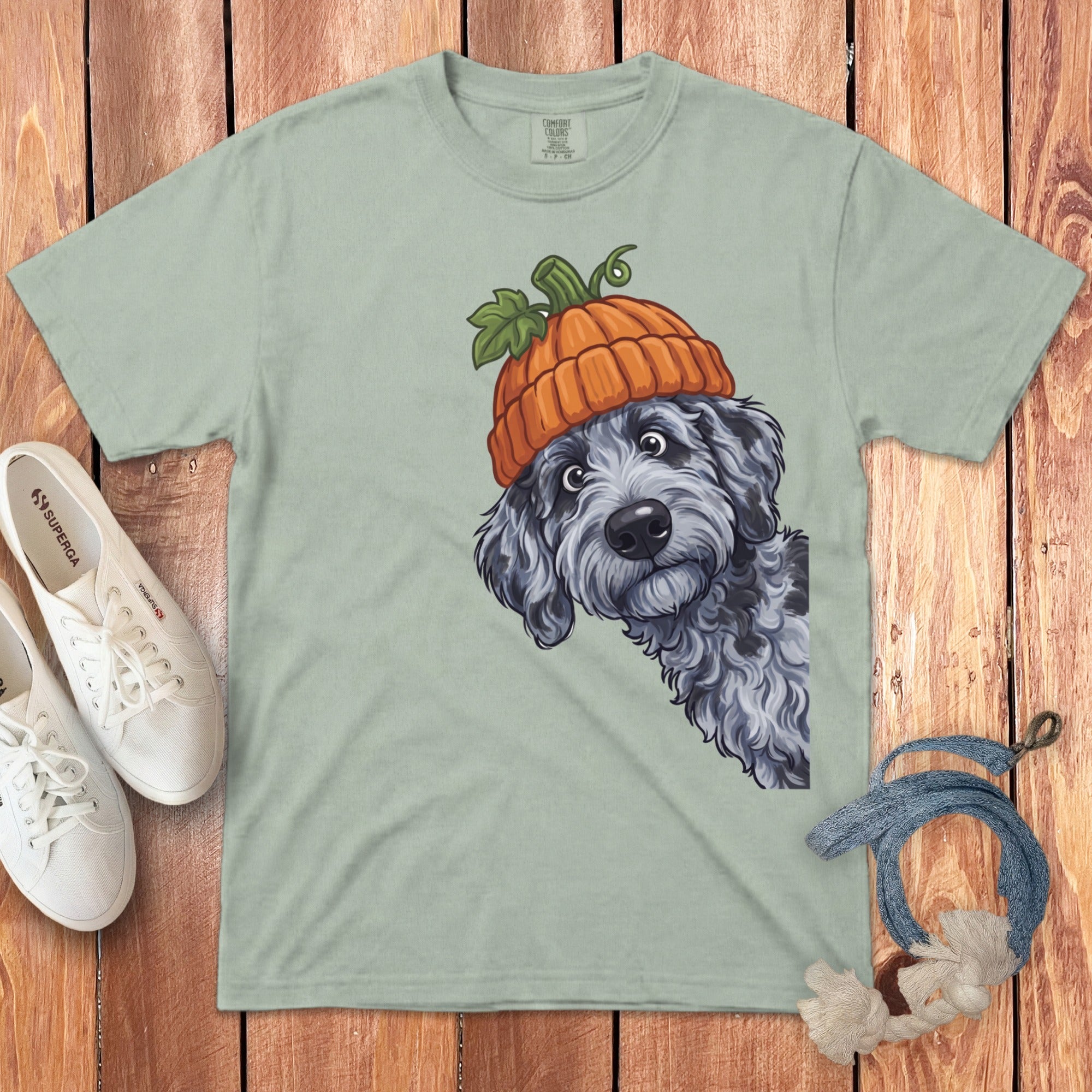 Light green t-shirt with doodle dog wearing a pumpkin hat graphic.