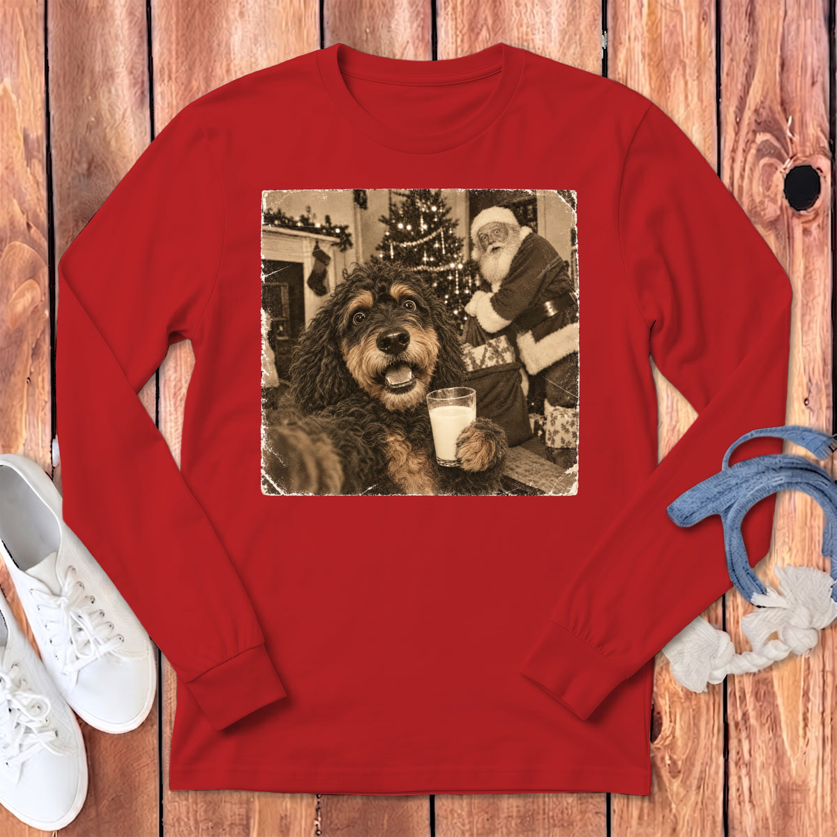 Red long-sleeve t-shirt featuring a black and white graphic of a dog holding a glass of milk with Santa Claus in the background.