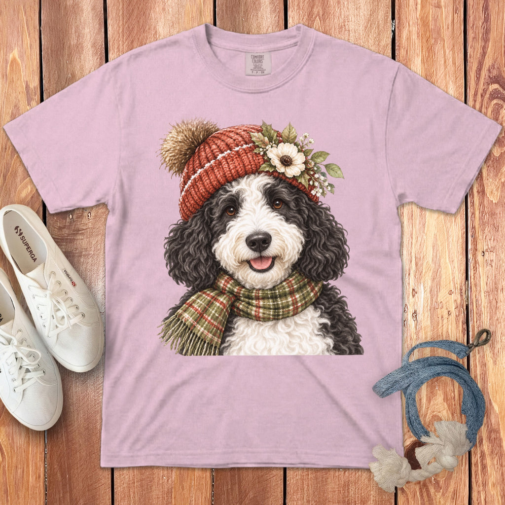 Pink t-shirt with a watercolor dog wearing a knitted hat and scarf.