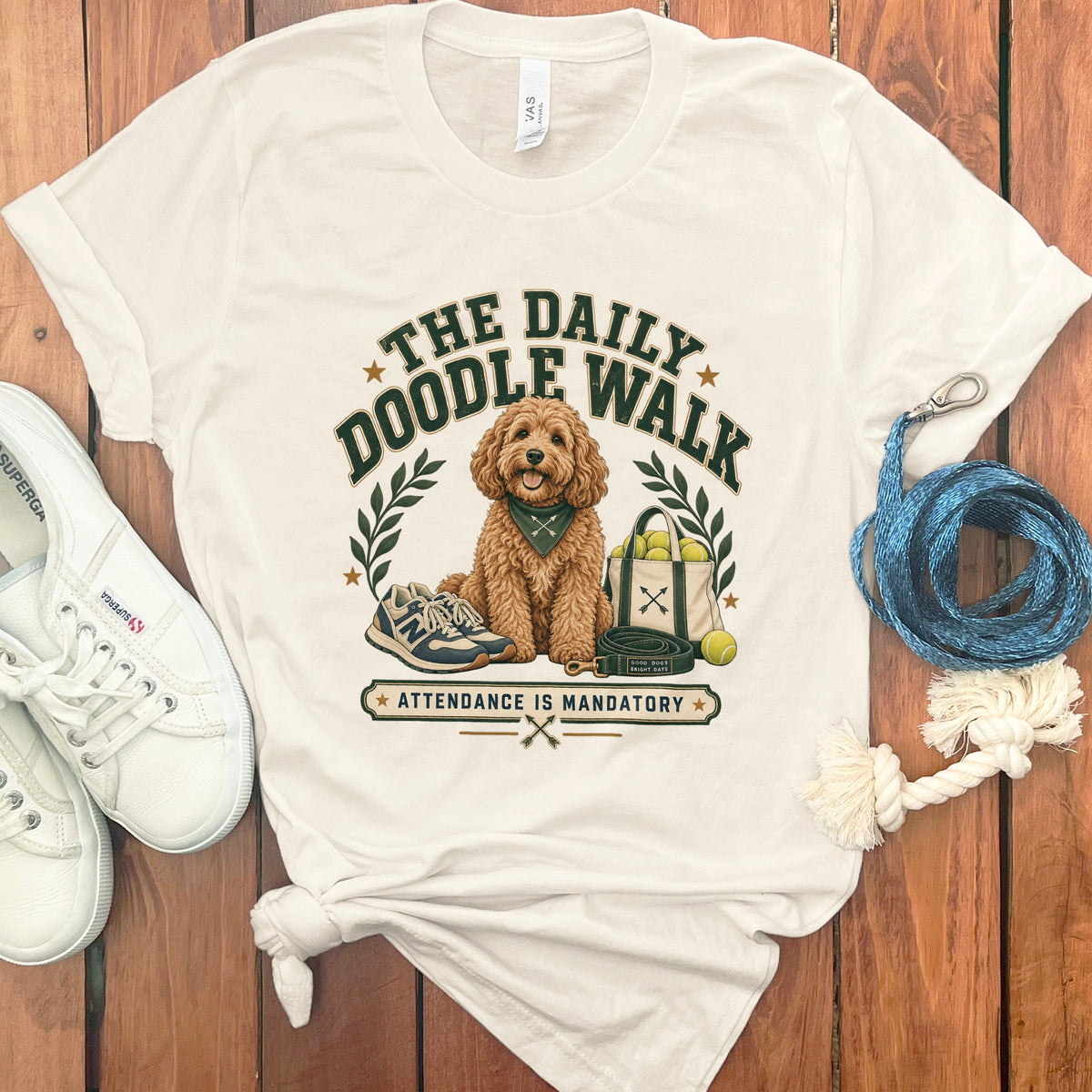 T-shirt graphic with doodle dog, leash, tennis balls, and "The Daily Doodle Walk" text.
