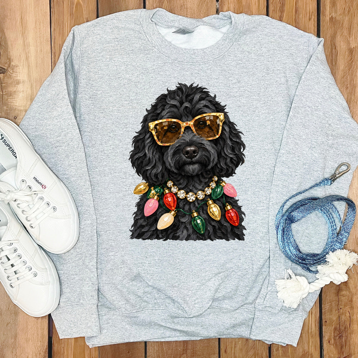 Grey sweatshirt with a black dog wearing sunglasses and a Christmas light necklace.