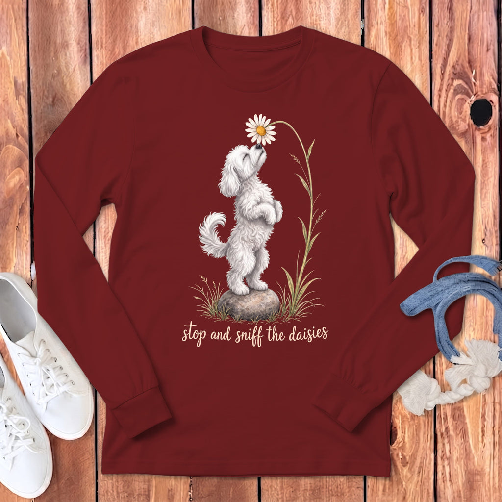 Maroon long-sleeve shirt with a white dog sniffing a daisy and text "stop and sniff the daisies".