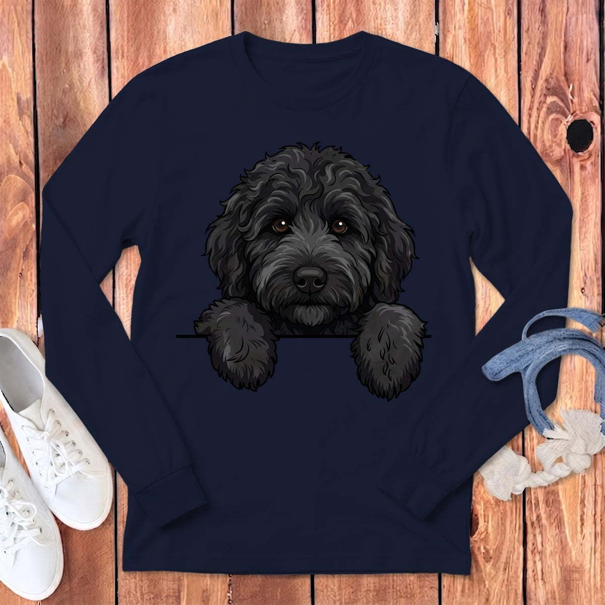Navy long sleeve shirt with a black doodle dog graphic peeking over a white line.