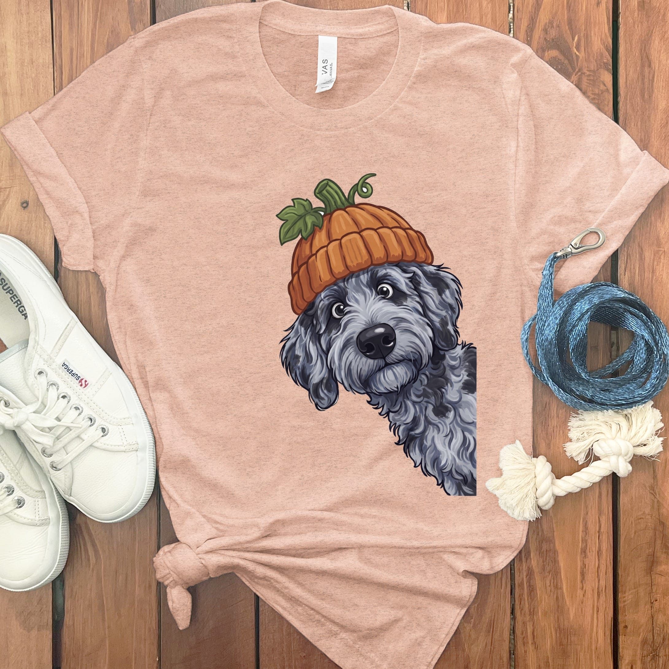 T-shirt with a cartoon dog wearing a pumpkin hat and two white sneakers.