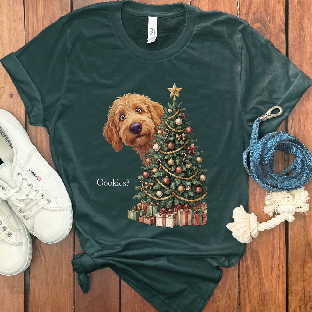 Green t-shirt with a doodle dog peeking behind a Christmas tree and presents.