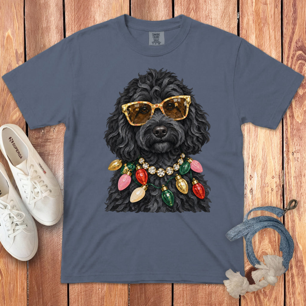 Black dog wearing sunglasses and a string of Christmas lights on a gray t-shirt.