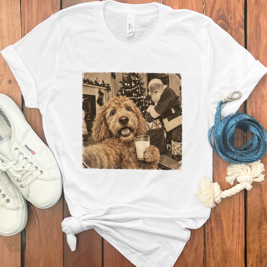 White t-shirt with a vintage graphic of a doodle dog holding a glass of milk near Santa.