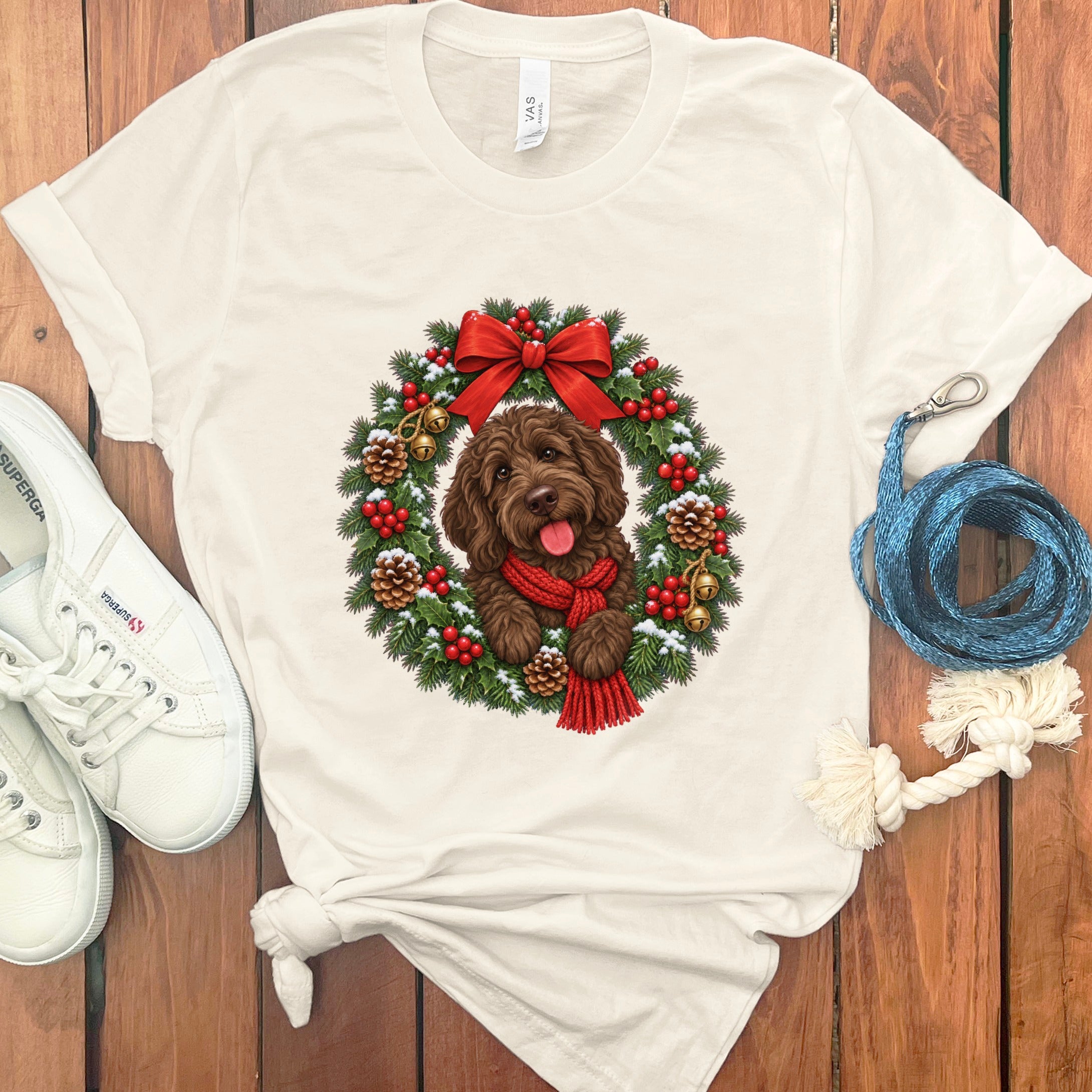 Cream crewneck t-shirt featuring a Christmas graphic of a brown doodle dog inside a decorated holiday wreath.