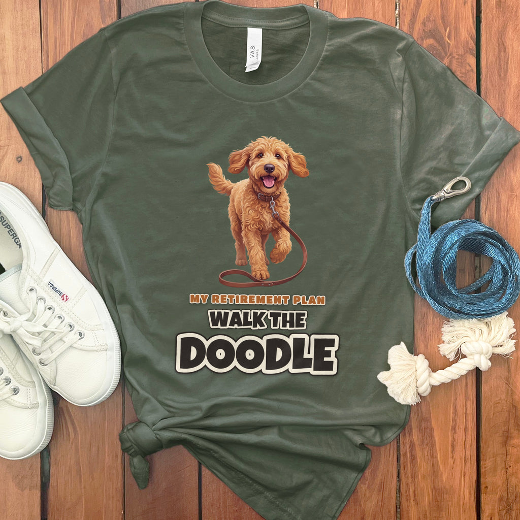 Olive green t-shirt with a doodle dog graphic and text "My Retirement Plan Walk The Doodle".