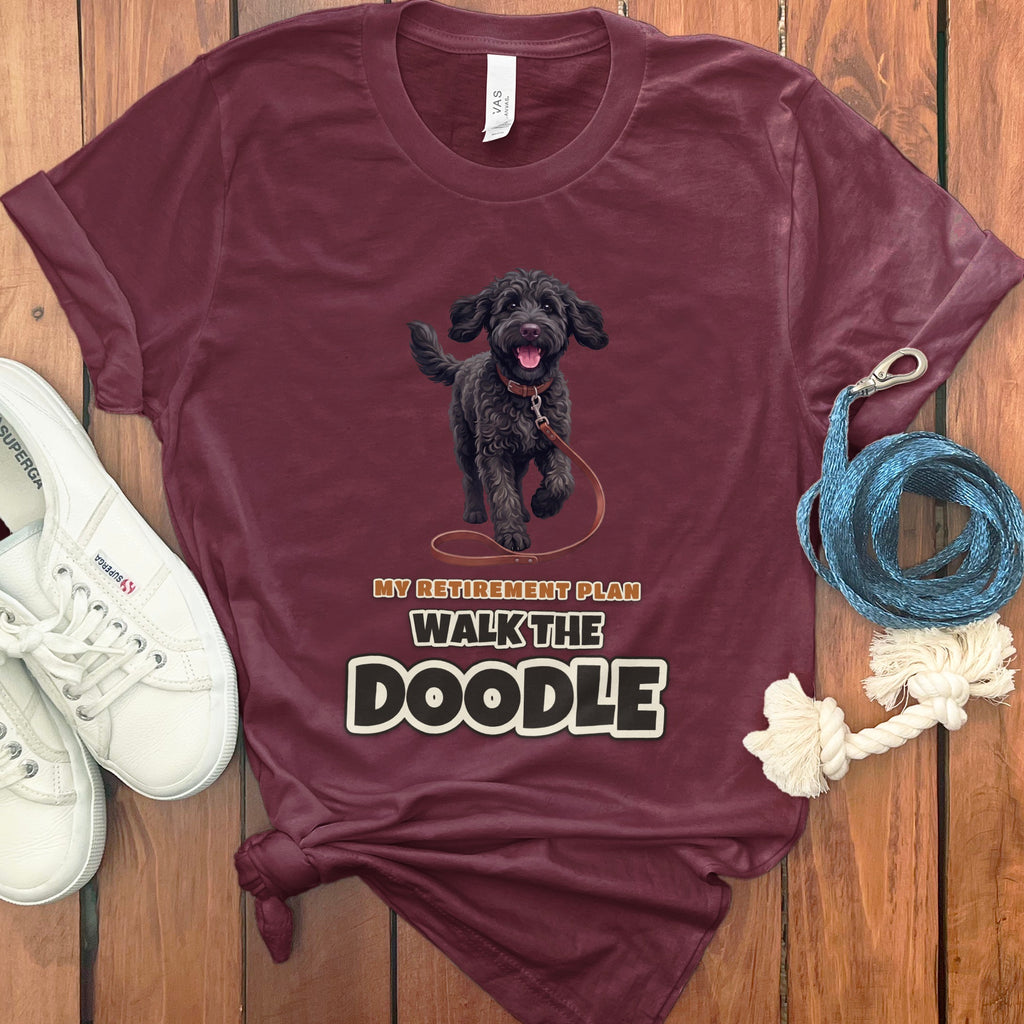 Maroon t-shirt with a black doodle dog graphic and text "MY RETIREMENT PLAN WALK THE DOODLE."