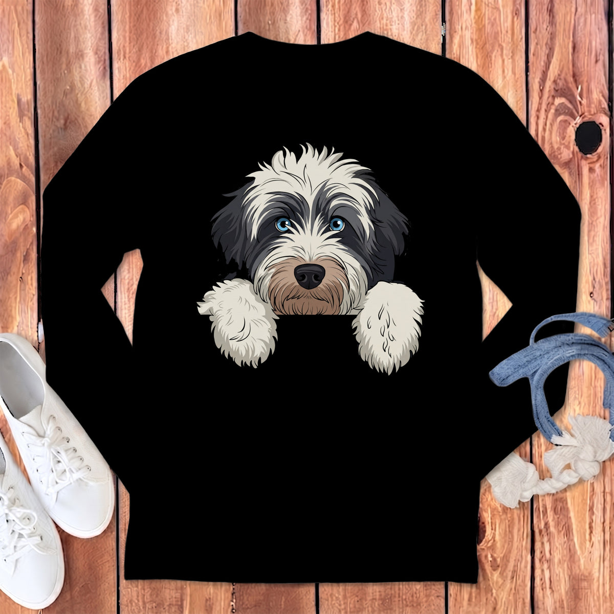 Black t-shirt with a white and black fluffy dog's face and paws.