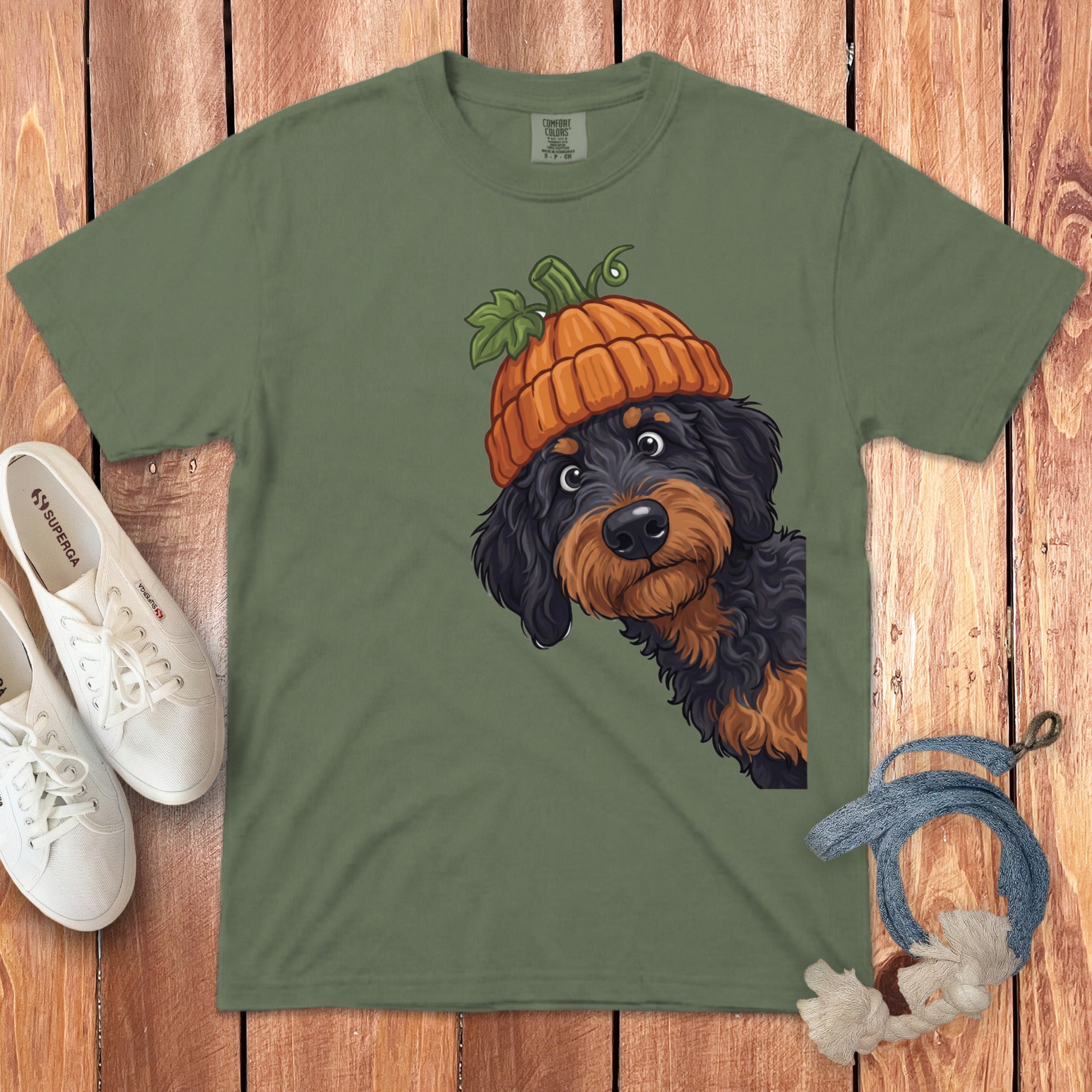 Green t-shirt with a dog wearing a pumpkin hat graphic.