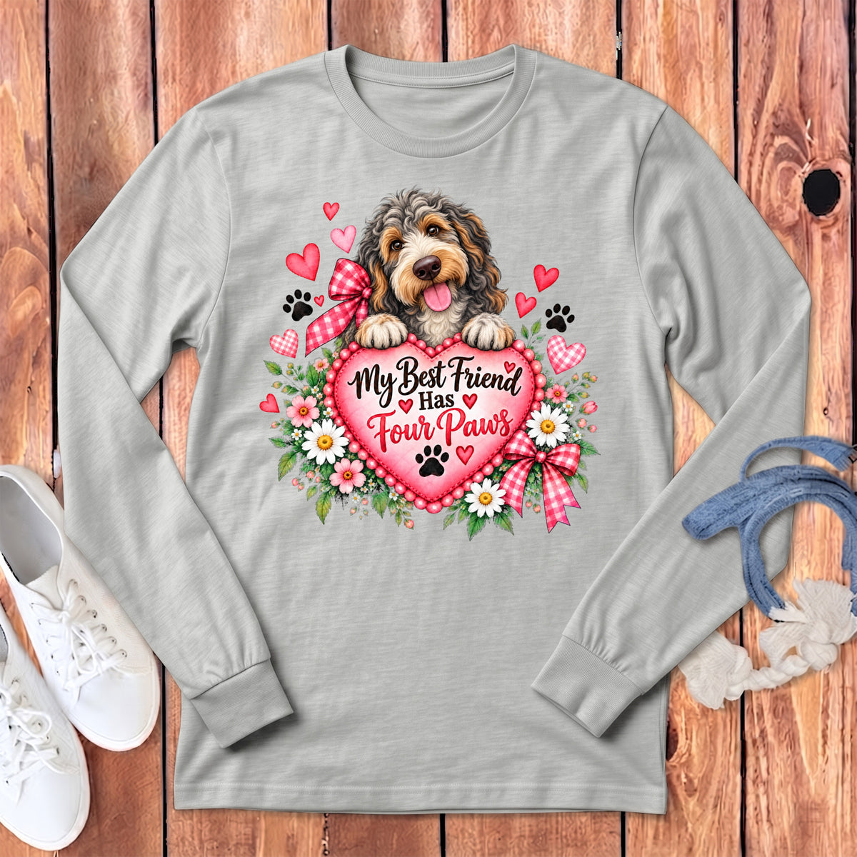 Light gray long-sleeve t-shirt with a graphic of a fluffy dog resting on a pink heart surrounded by flowers and text.