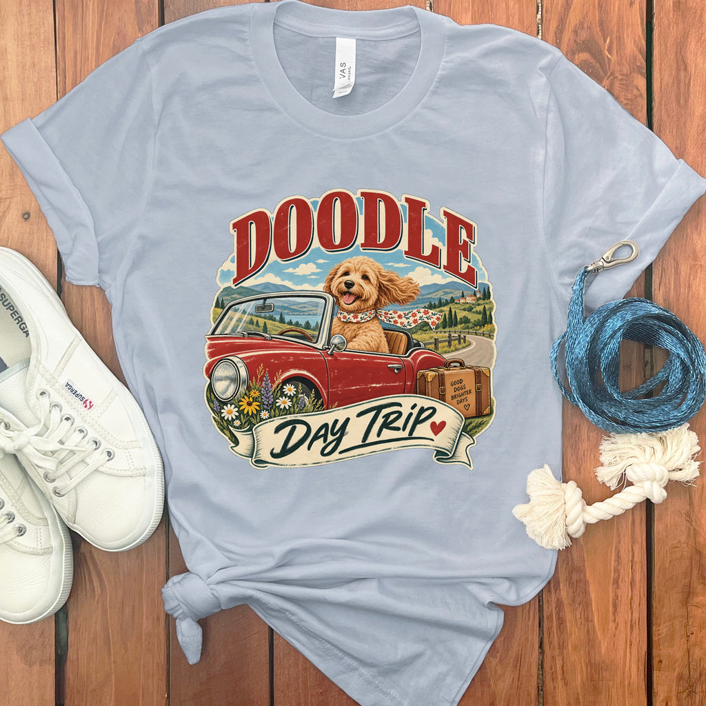 Light blue t-shirt with doodle dog driving a red convertible, text "Doodle Day Trip".