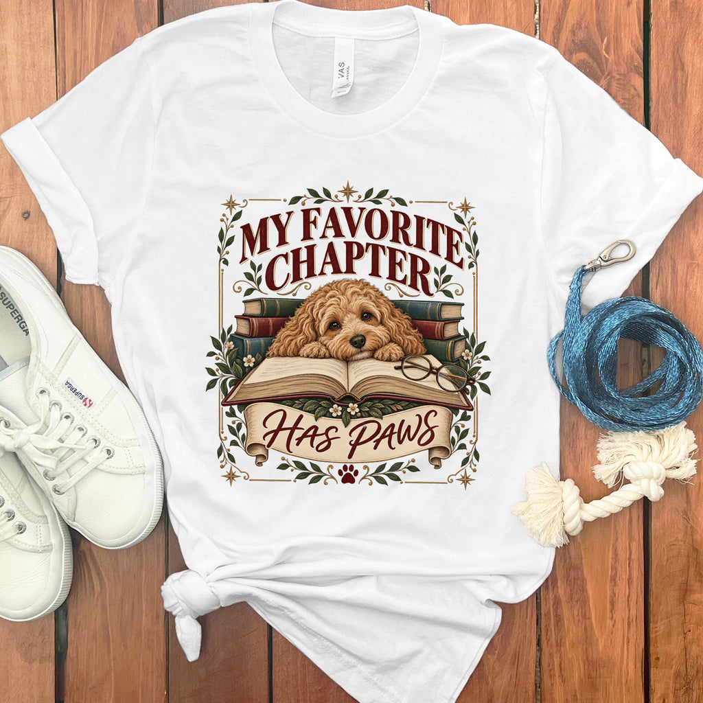White t-shirt with "My Favorite Chapter Has Paws" graphic featuring a dog and books.