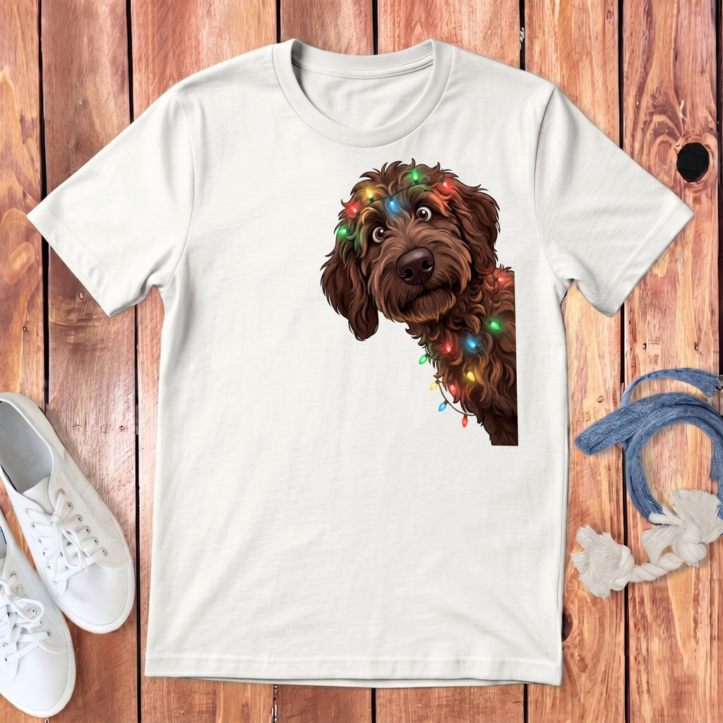 White t-shirt featuring a brown dog peeking out, adorned with colorful Christmas lights.