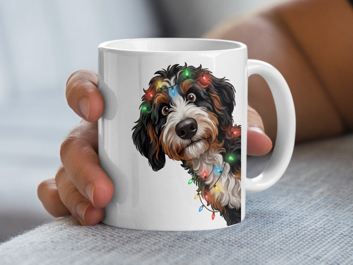 White mug with a Bernese Mountain Dog wearing festive Christmas lights.