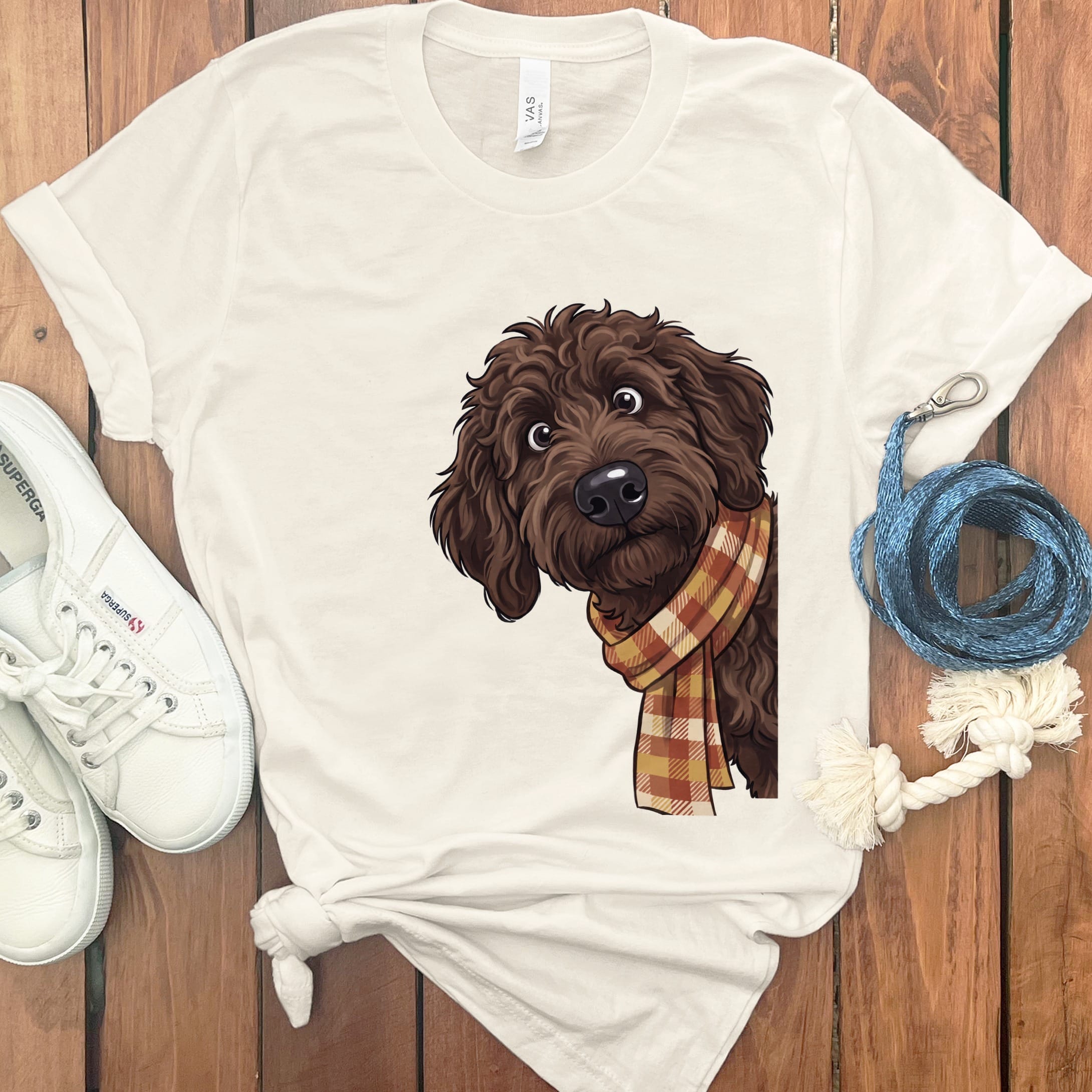 Cream t-shirt with brown dog wearing plaid scarf graphic.