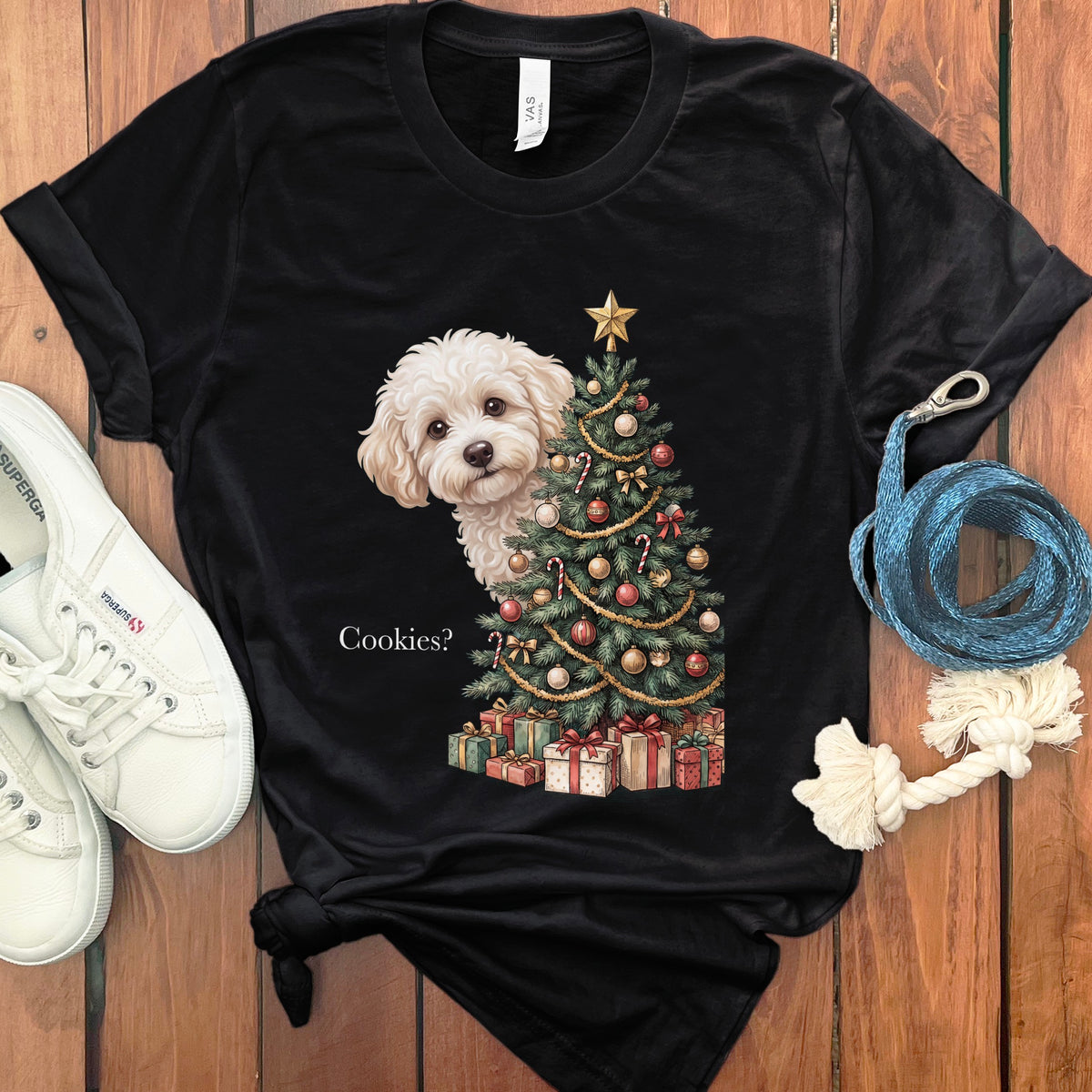 Black t-shirt with a fluffy white dog peeking from behind a decorated Christmas tree.
