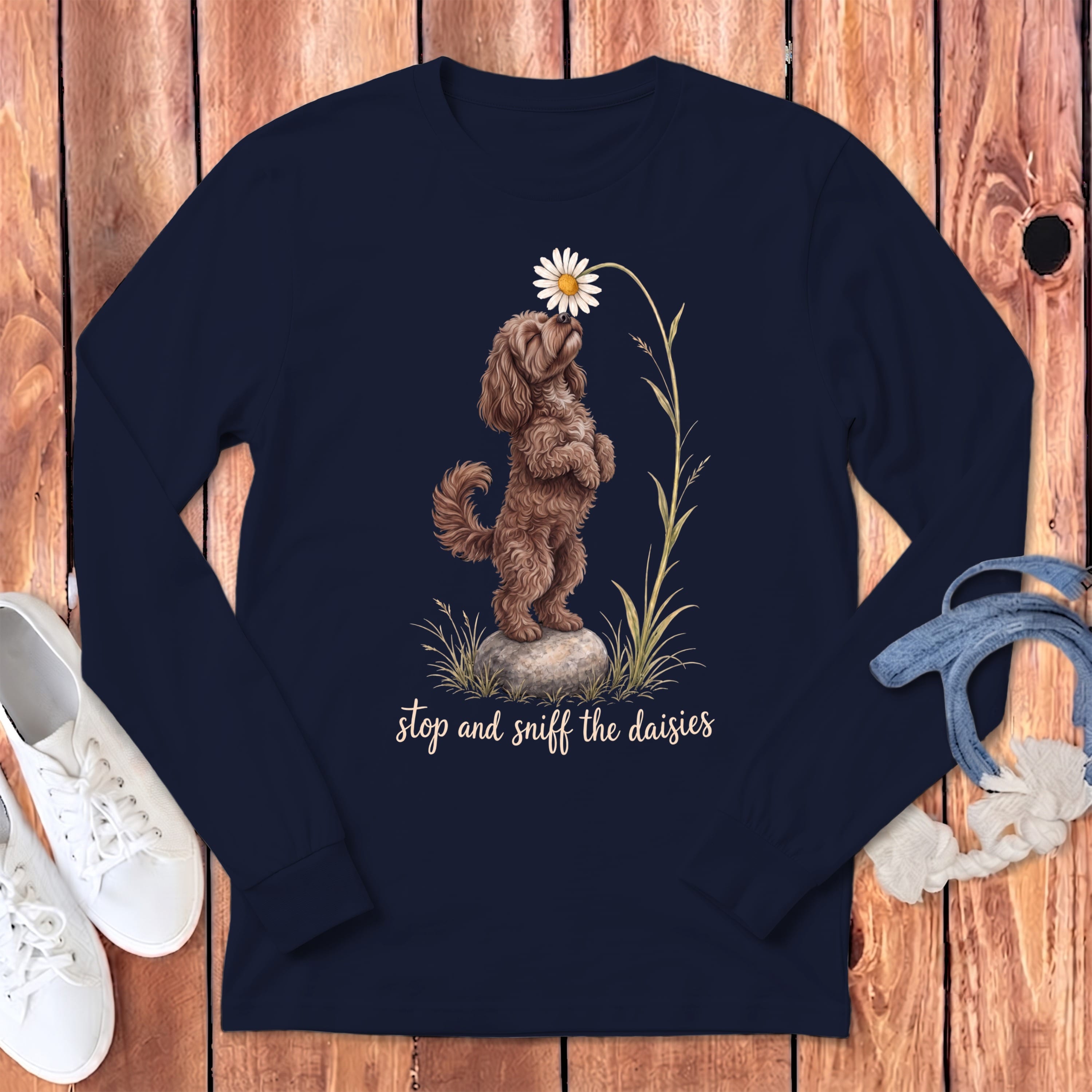 Navy long-sleeve shirt with a brown dog smelling a daisy and text "stop and sniff the daisies".