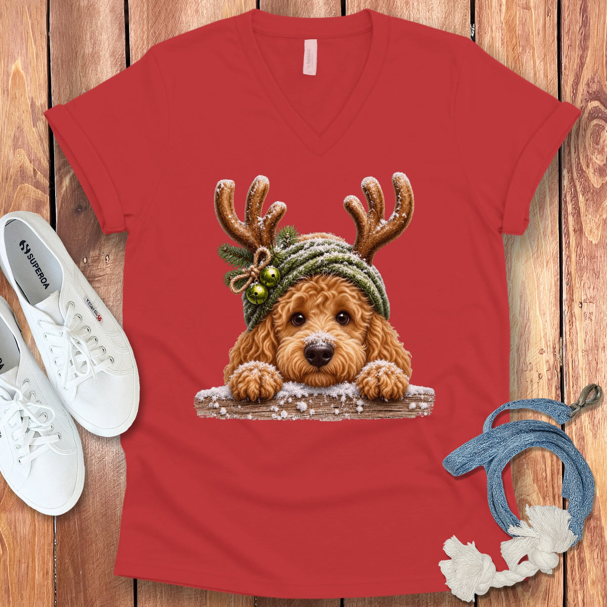 Red v-neck t-shirt with a cute dog wearing reindeer antlers and a winter hat.