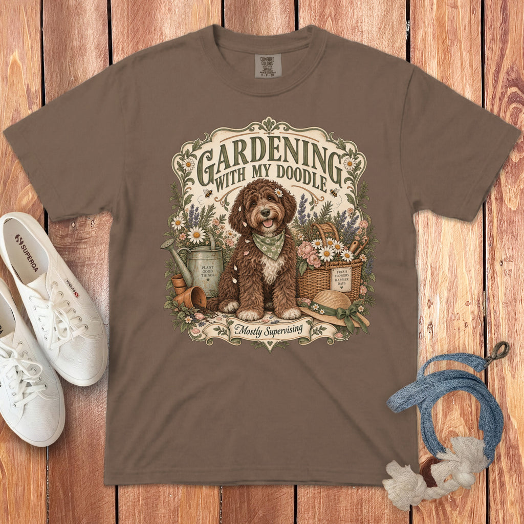 Brown t-shirt with a doodle dog and gardening illustration, text reads "Gardening with My Doodle".
