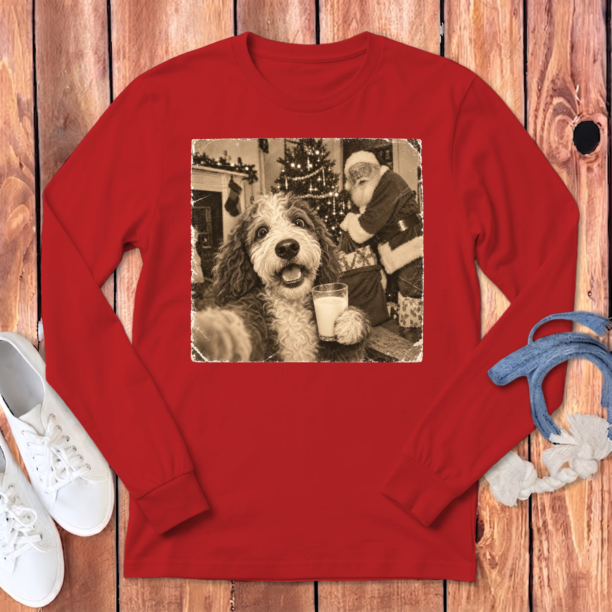 Bright red long-sleeved shirt with a black and white graphic of a fluffy dog holding a glass of milk near Santa Claus.