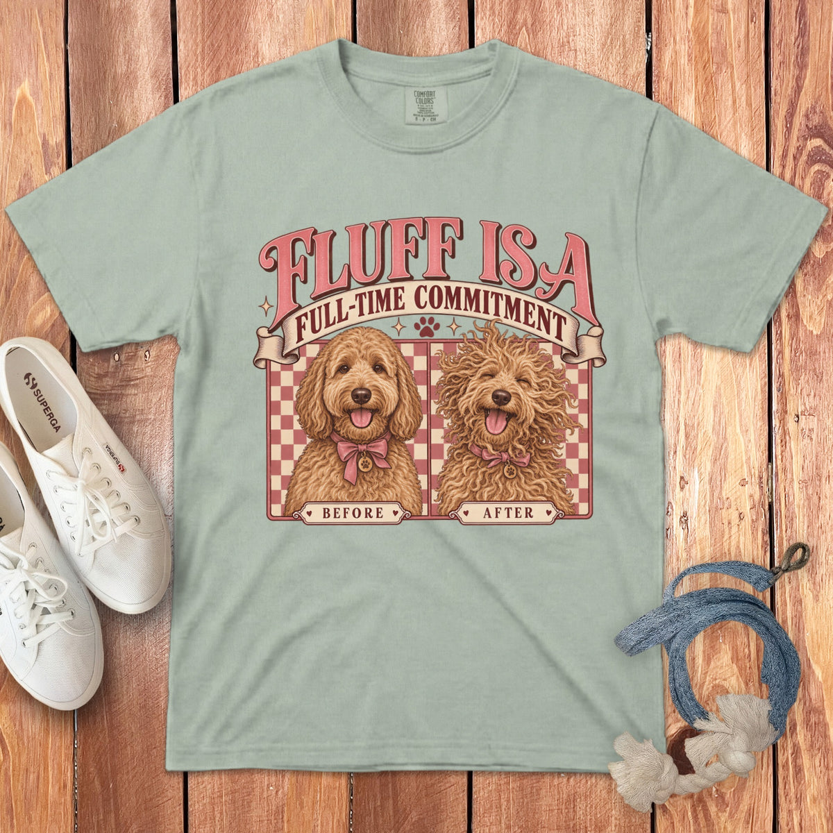 Sage green t-shirt featuring a retro cartoon graphic of a before-and-after doodle dog labeled Fluff Is a Full-Time Commitment.