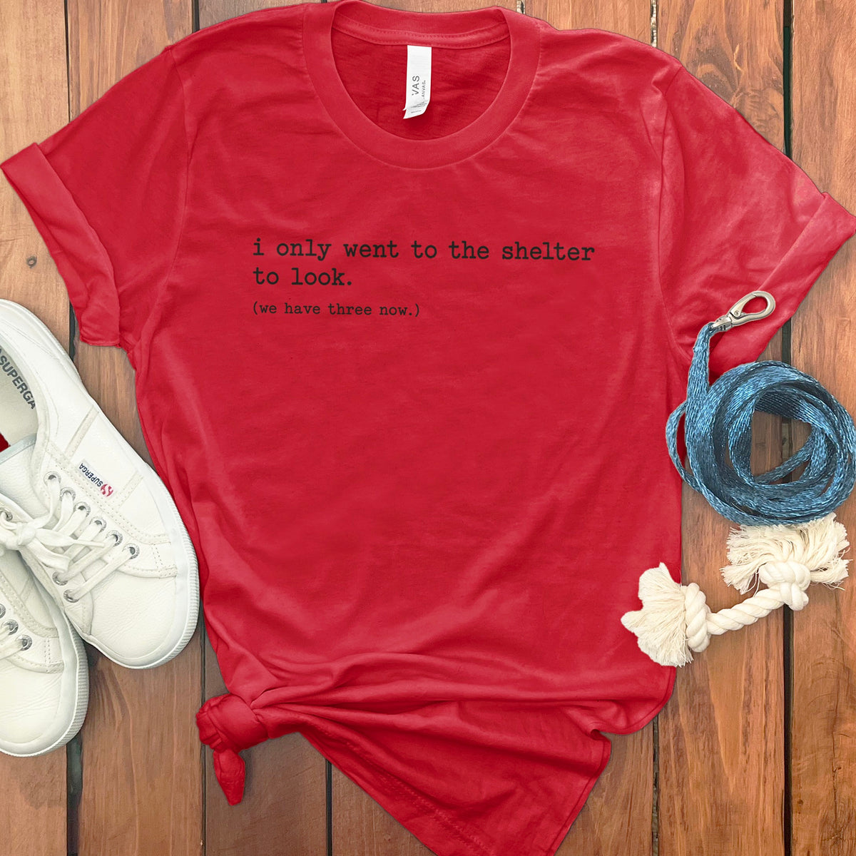 Red t-shirt with black text reading "i only went to the shelter to look. (we have three now.)"