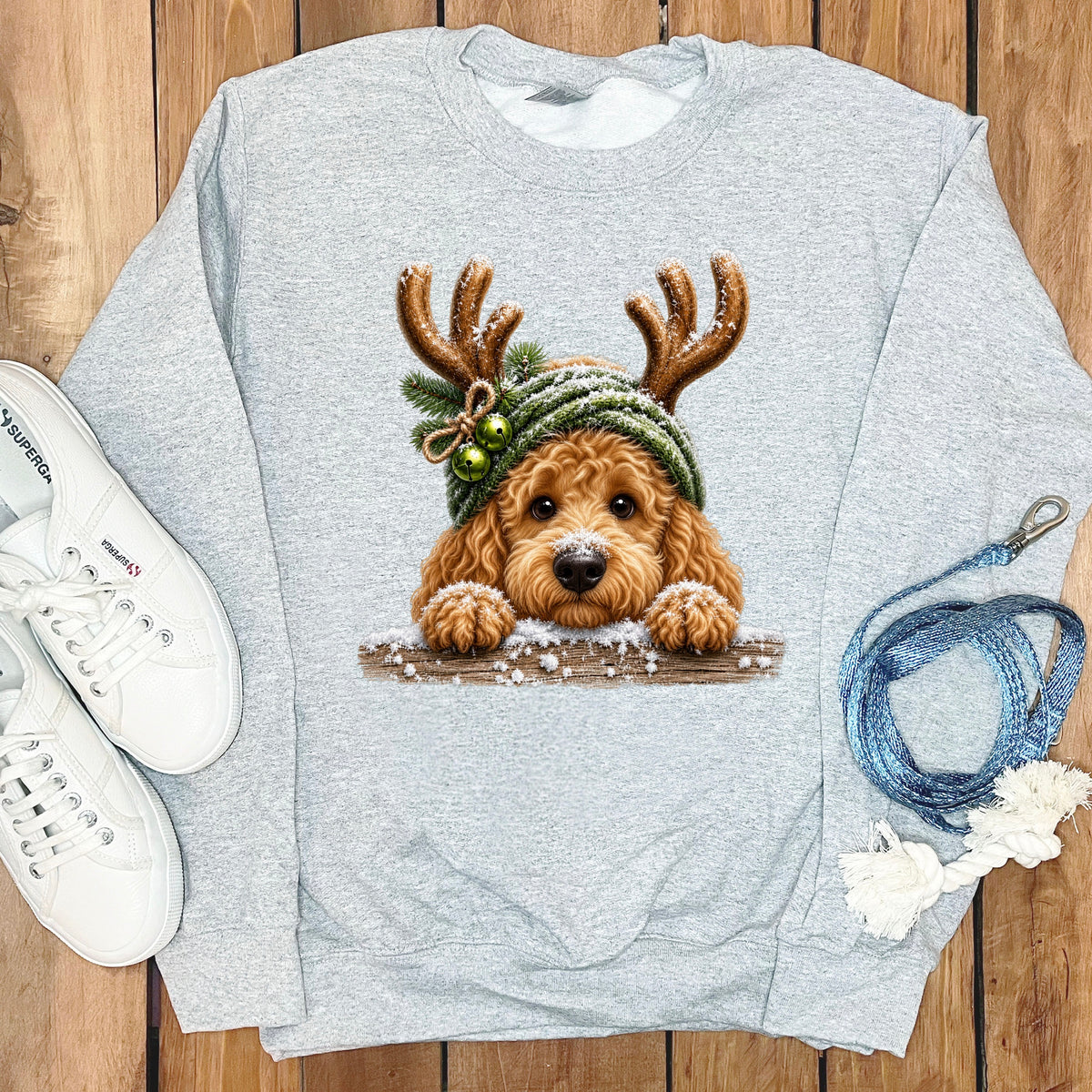 Light grey sweatshirt with a cartoon dog wearing reindeer antlers and a hat.