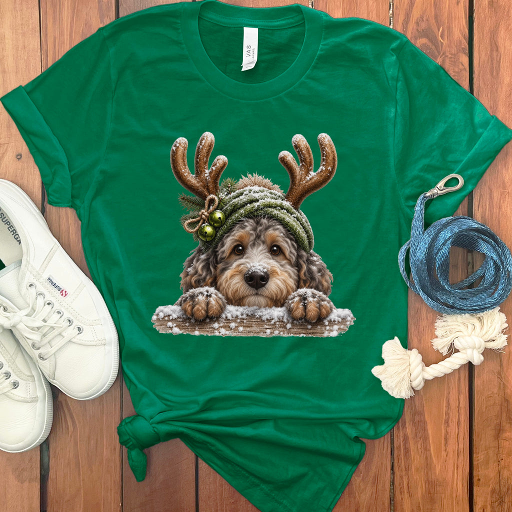 Green t-shirt with a festive doodle dog wearing antlers and a knit hat.