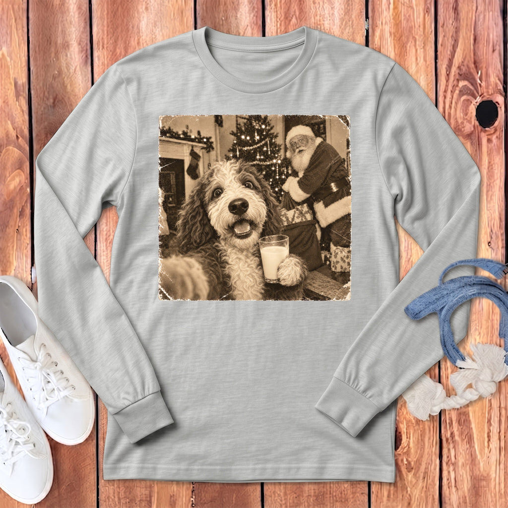 A light gray long-sleeve t-shirt features a vintage sepia print of a dog holding a glass of milk while Santa Claus stands in the background.