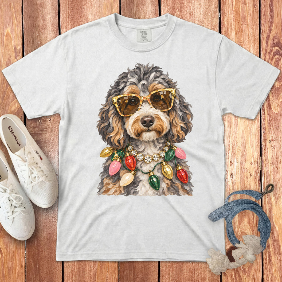 White t-shirt with a watercolor dog wearing sunglasses and a Christmas light necklace.