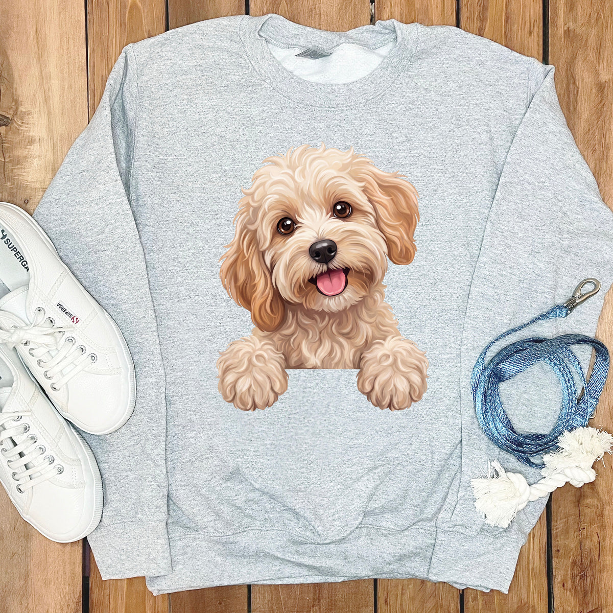 Light grey sweatshirt with a smiling golden doodle dog graphic and white Superga sneakers.
