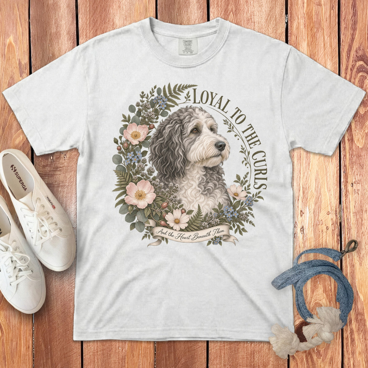 White t-shirt with dog illustration, floral wreath, and text "Loyal to the Curls".