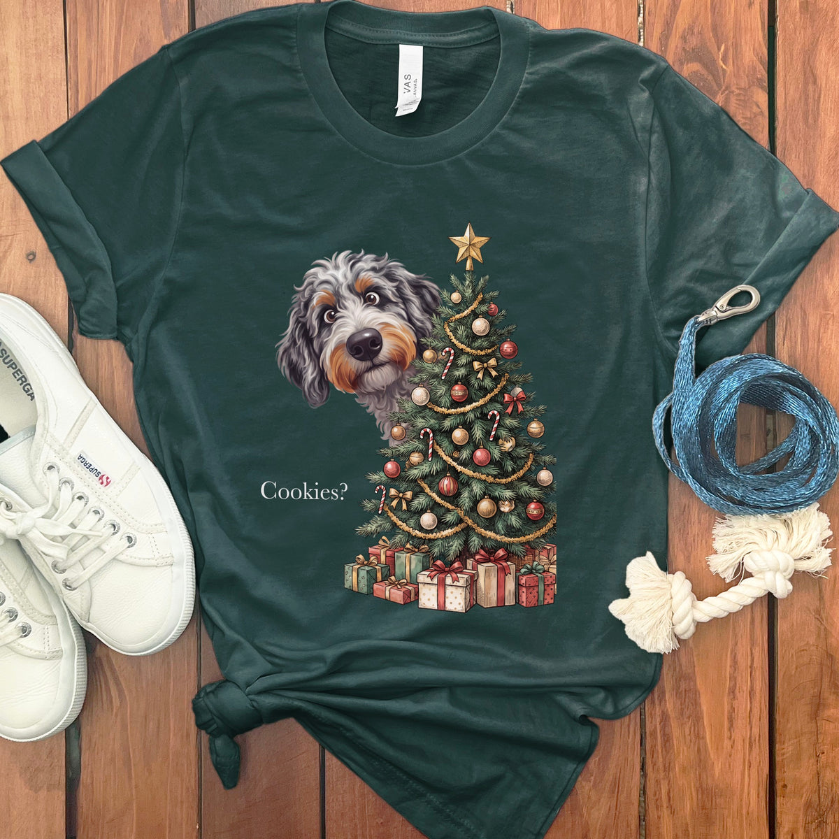 Fluffy dog peeking from behind a Christmas tree with presents and "Cookies?" text.