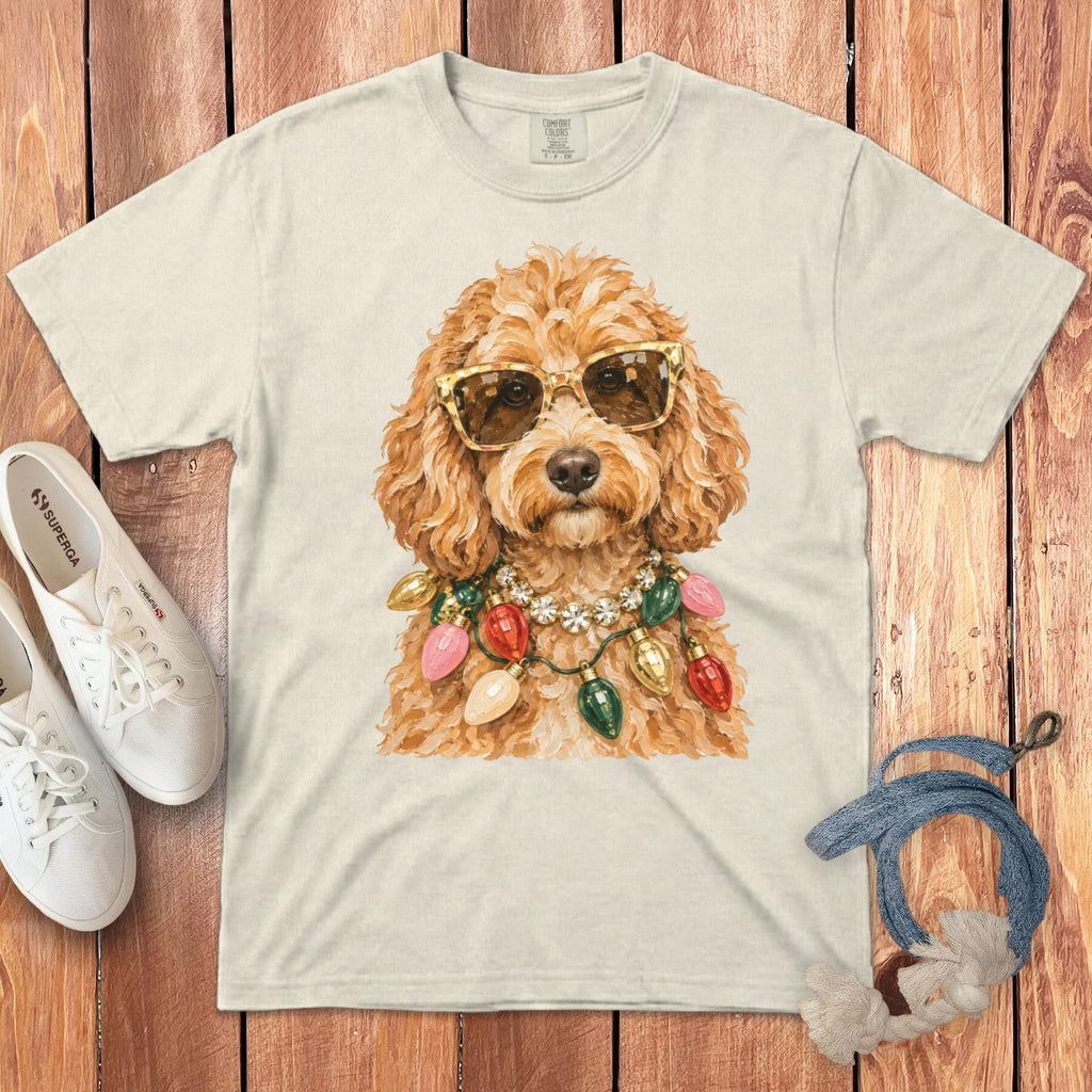 Cream t-shirt with fluffy dog wearing sunglasses and string lights necklace.
