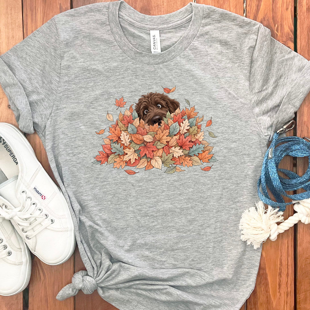 Chocolate Goldendoodle Peeking Leaf Pile T-Shirt in Athletic Heather / S by Puppy Jo