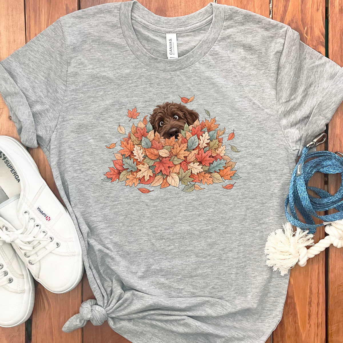 Chocolate Goldendoodle Peeking Leaf Pile T-Shirt in Athletic Heather / S by Puppy Jo