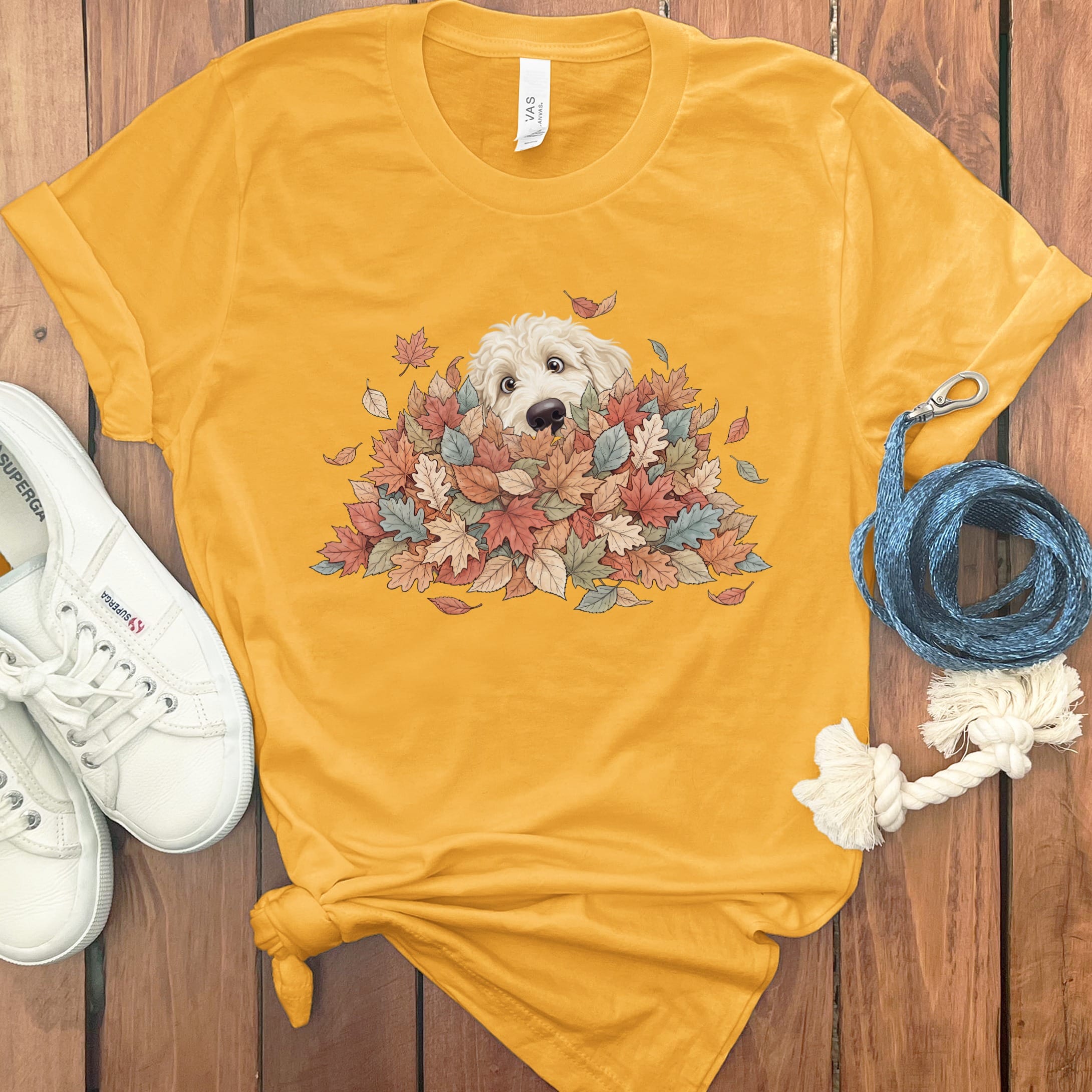 Cream Goldendoodle Peeking Leaf Pile T-Shirt in Gold / S by Puppy Jo