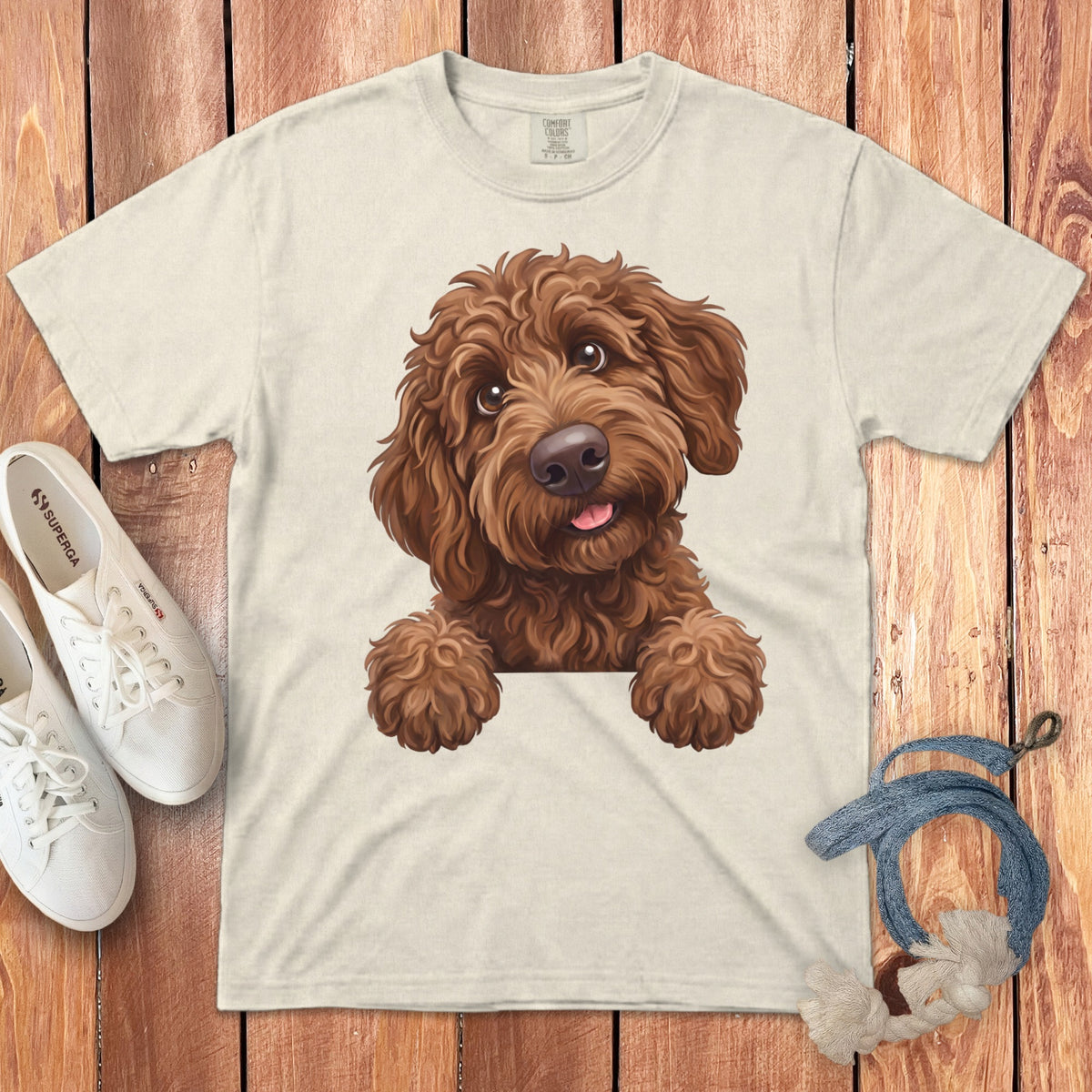 Cream t-shirt with brown doodle dog graphic, white Superga shoes, and rope toy.