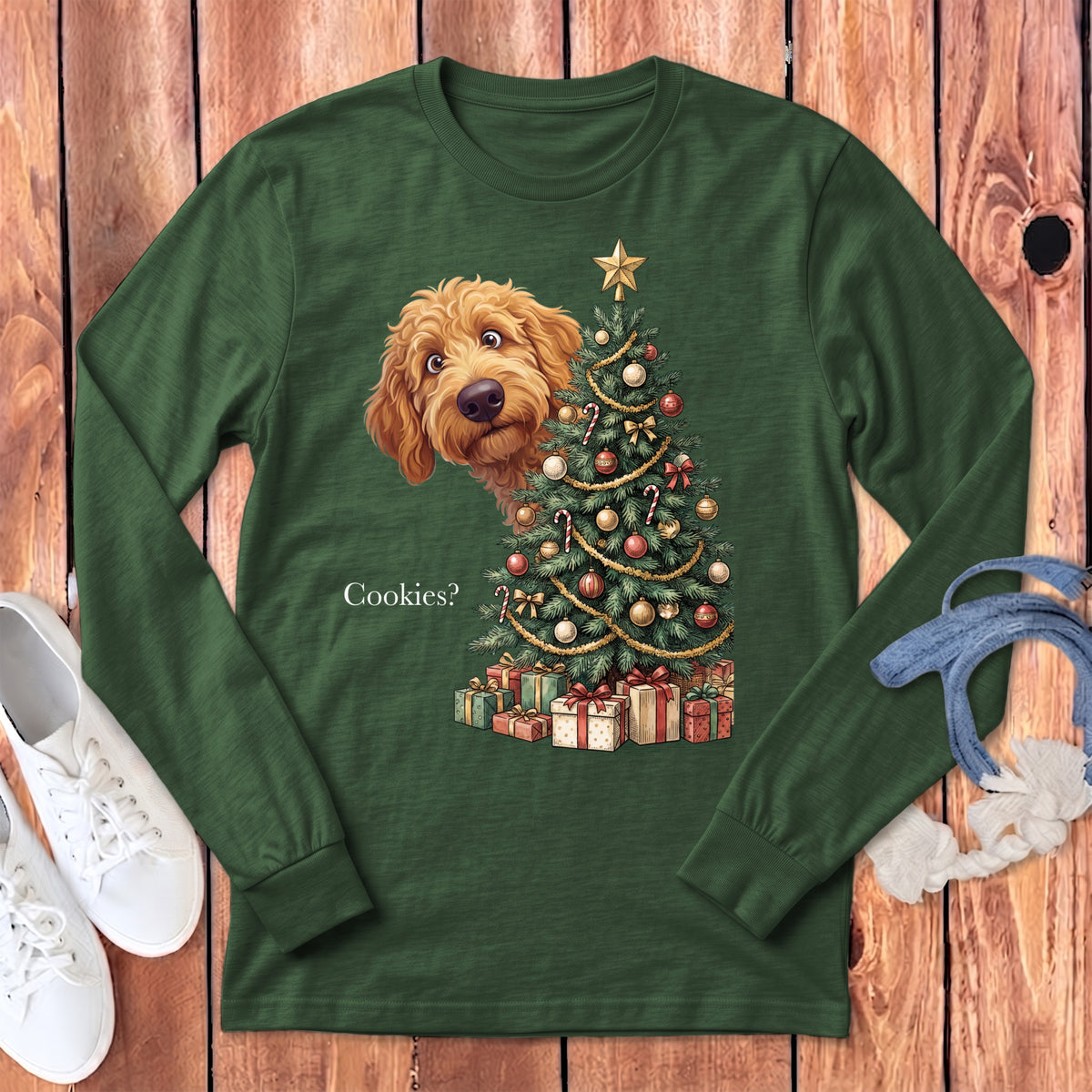 Green long-sleeve shirt with a golden doodle peeking by a Christmas tree and gifts.