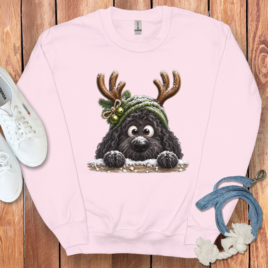 Pink sweatshirt with a cartoon black dog wearing reindeer antlers and a green beanie.