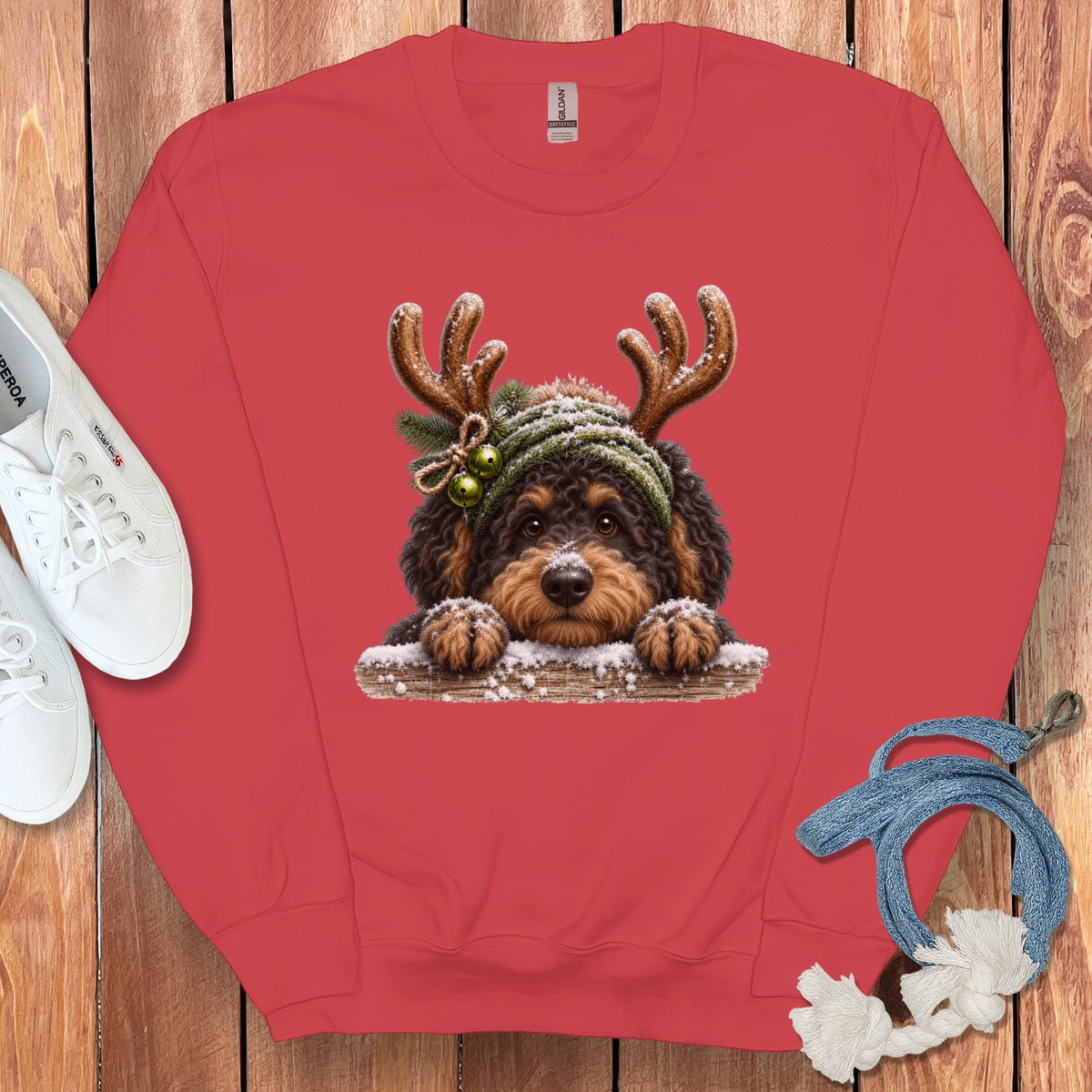 Red sweatshirt with a cartoon dog wearing reindeer antlers and a green hat.
