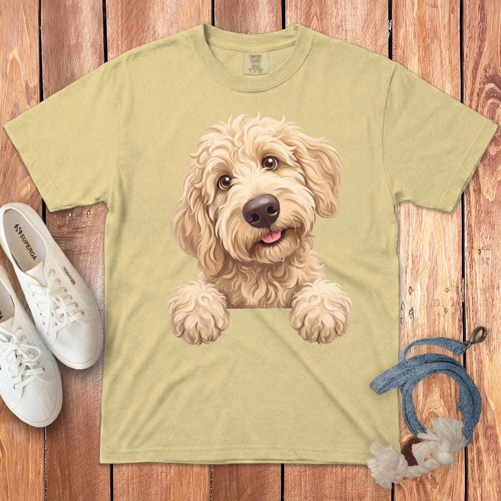Light yellow t-shirt with a cartoon doodle dog print, sneakers, and dog toy.