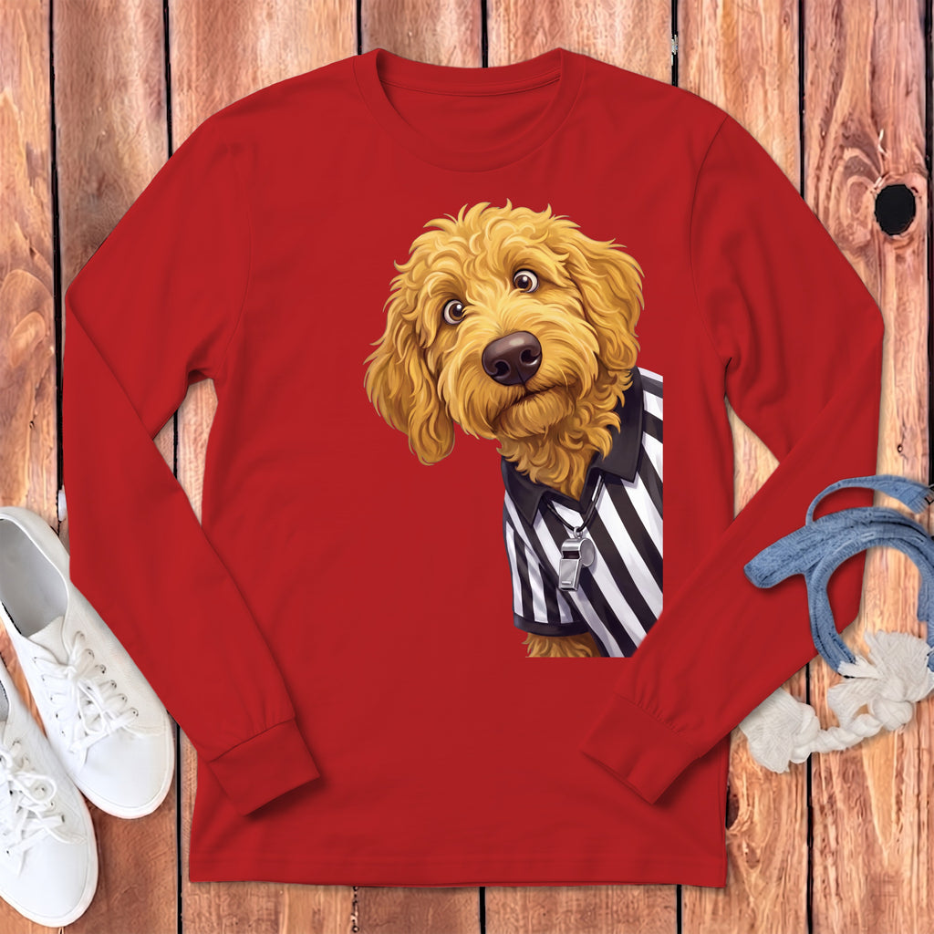 Golden doodle dog wearing referee shirt and holding a whistle.
