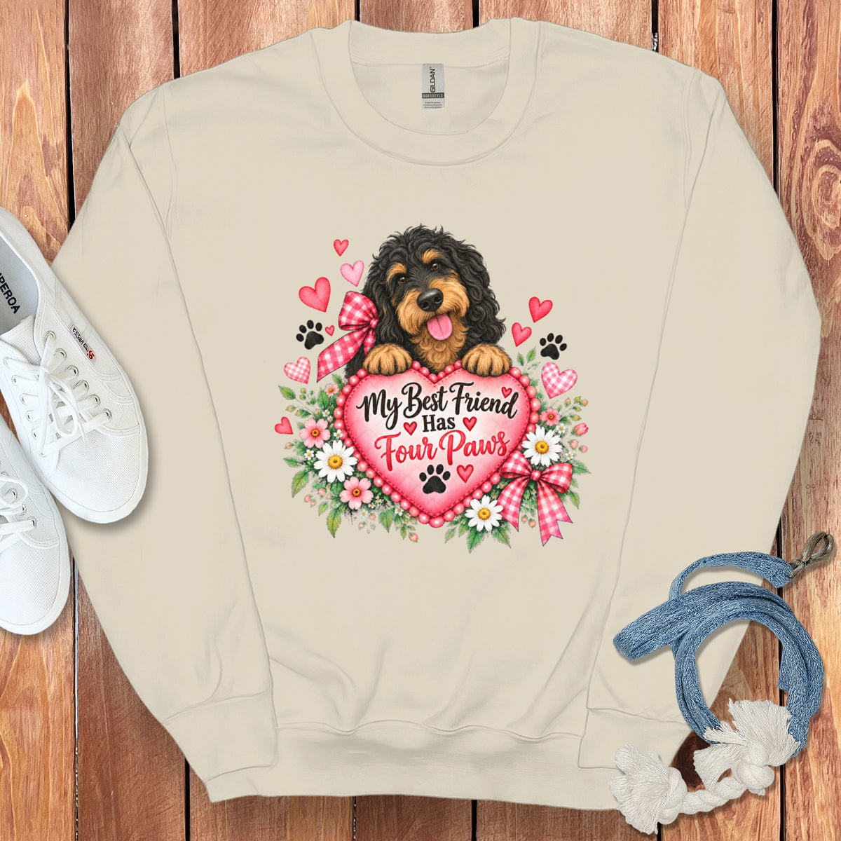 Beige crewneck sweatshirt with a graphic of a Bernedoodle dog holding a heart that reads My Best Friend Has Four Paws.