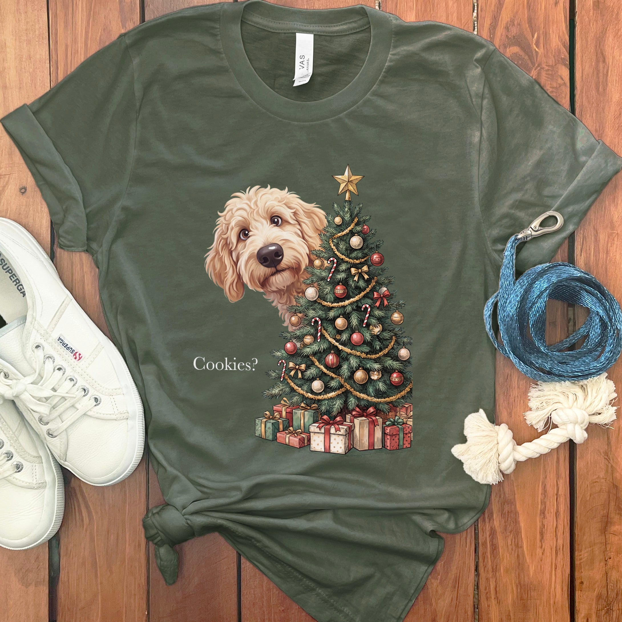 Goldendoodle peeking from behind a decorated Christmas tree with gifts and text "Cookies?".