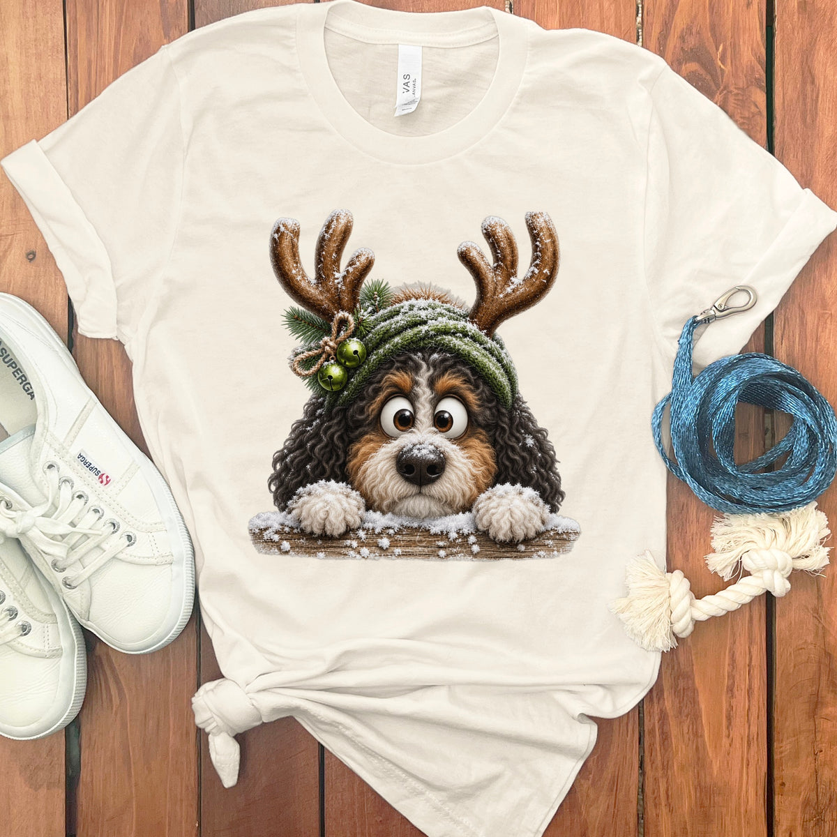 Bernese Mountain Dog in Christmas reindeer antlers and hat with bells.